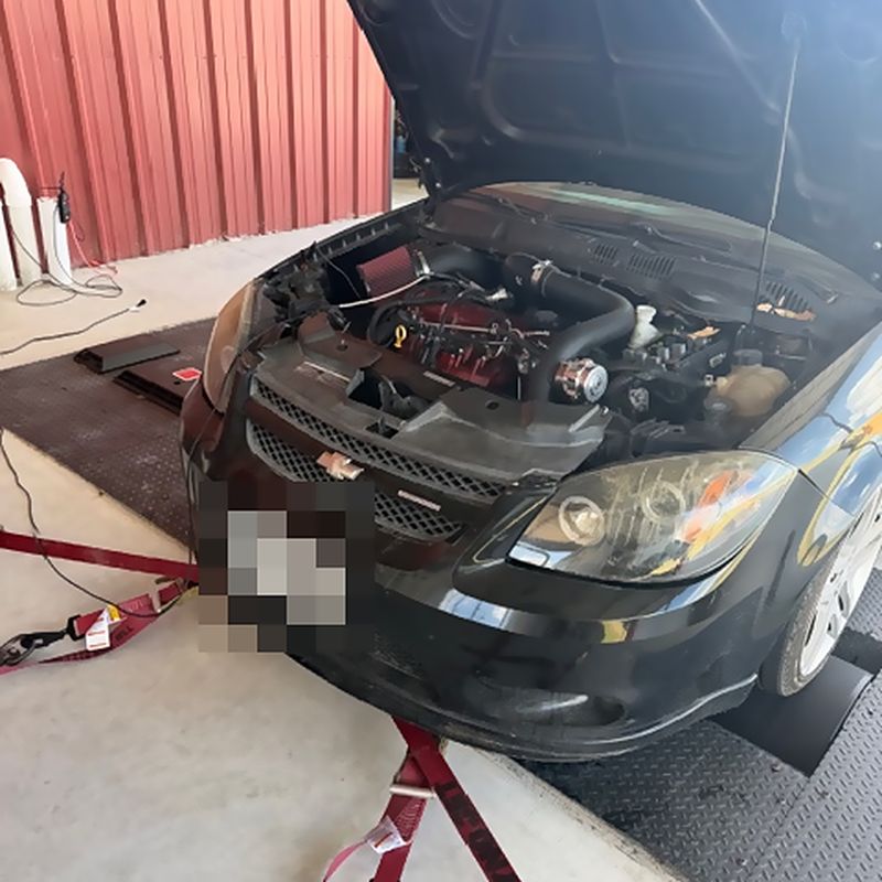 A Chevrolet Cobalt on the rollers with the hood open